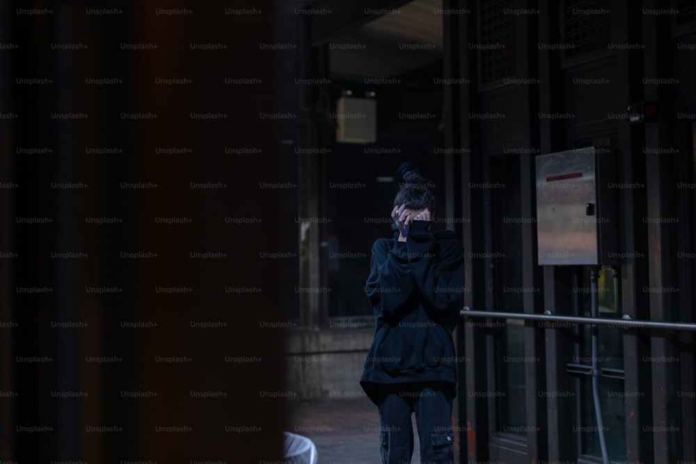 a woman walking down a street talking on a cell phone