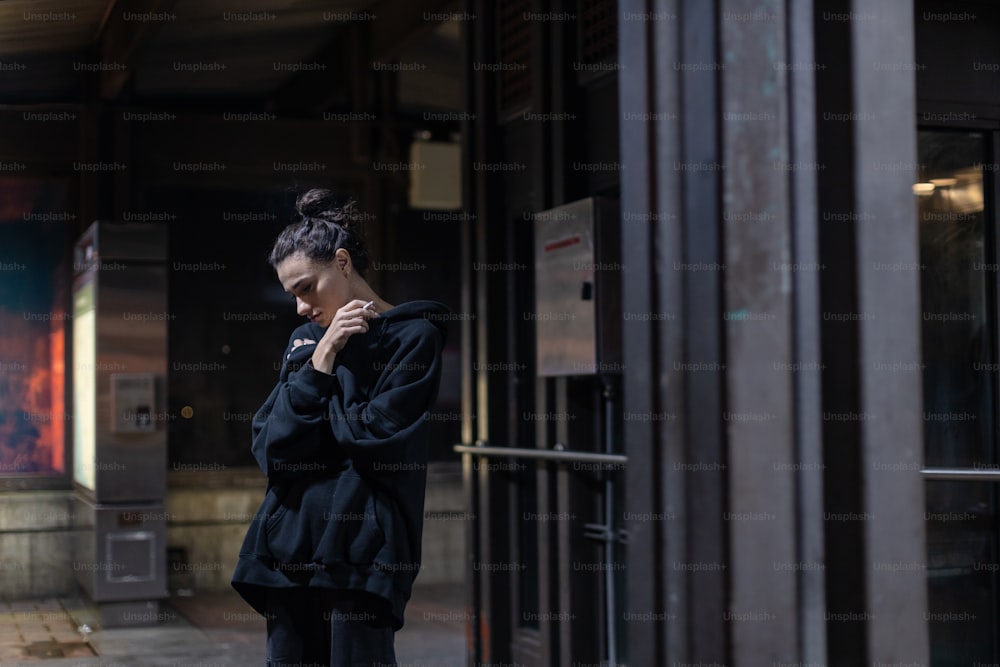 a woman is standing outside of a building