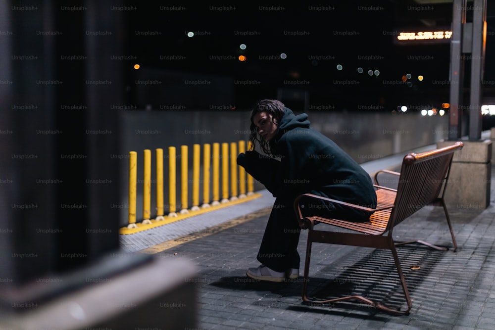 a man sitting in a chair on a sidewalk