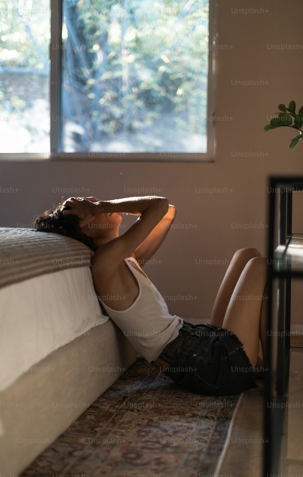 a woman laying on a bed in a room