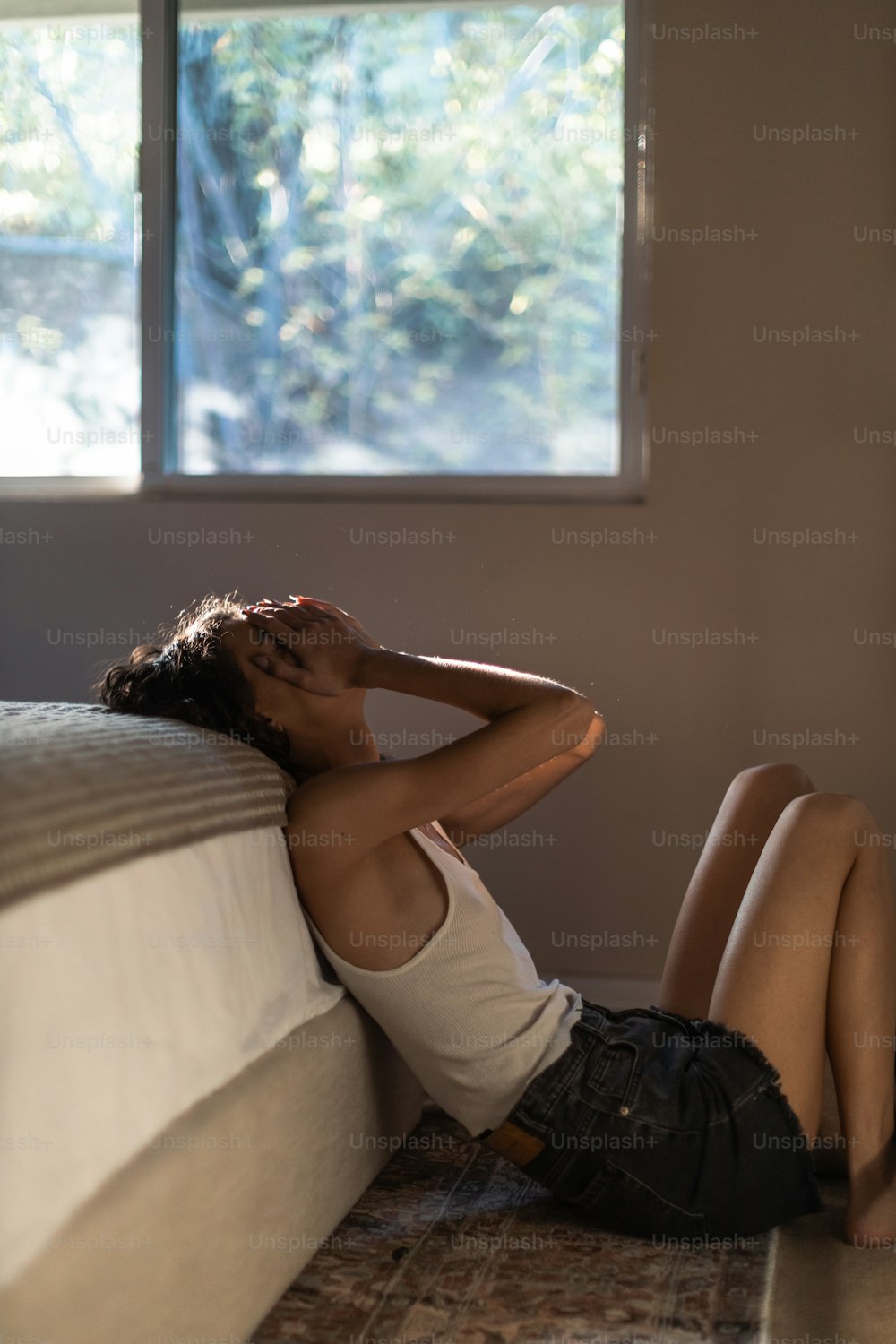 a woman laying on a bed with her legs crossed