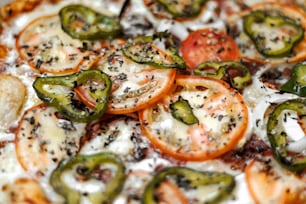 a close up of a pizza with tomatoes and cheese