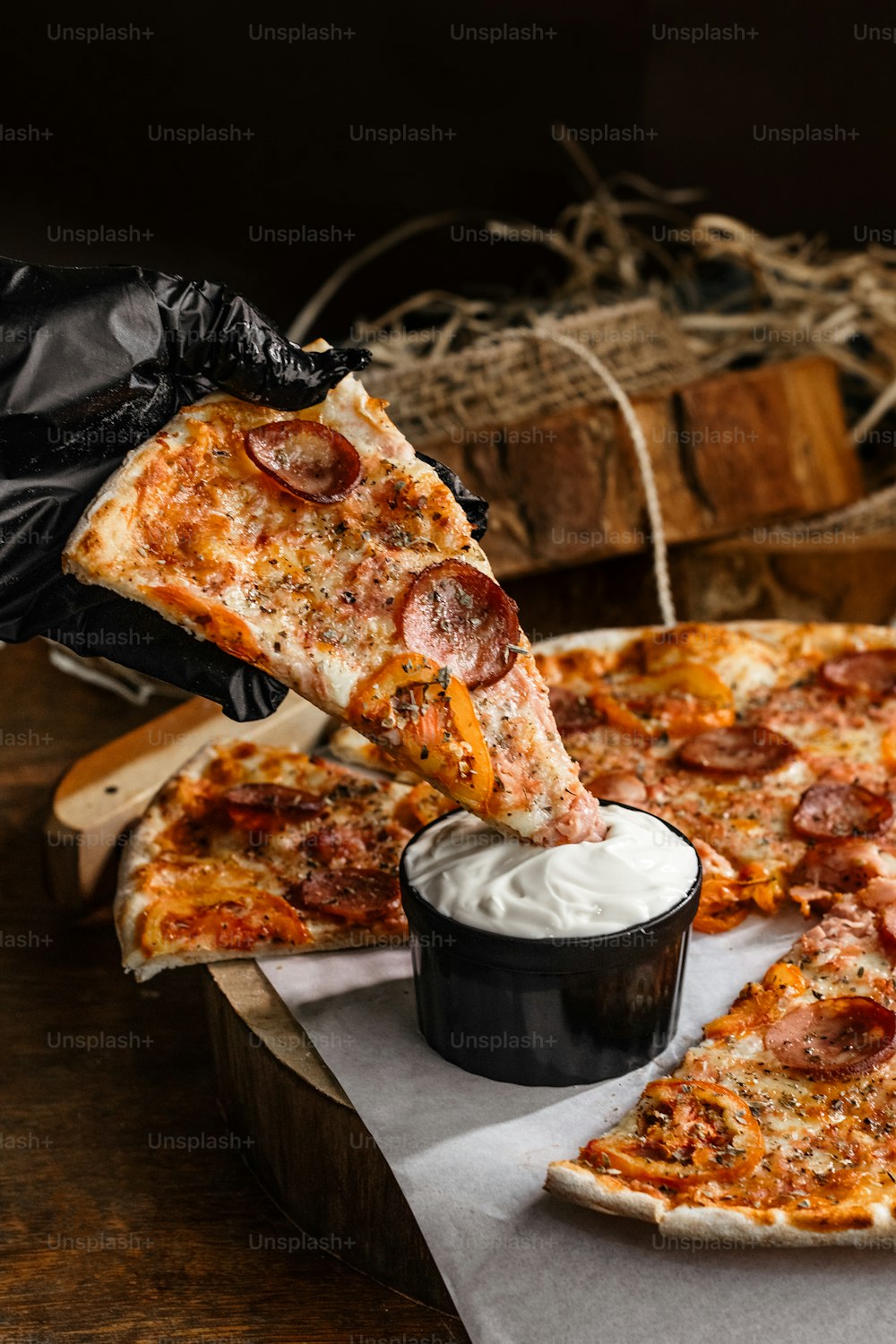 a person taking a slice of pizza from a box