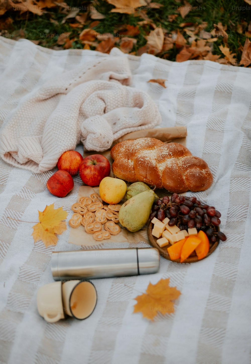 a bunch of food that is laying out on a blanket