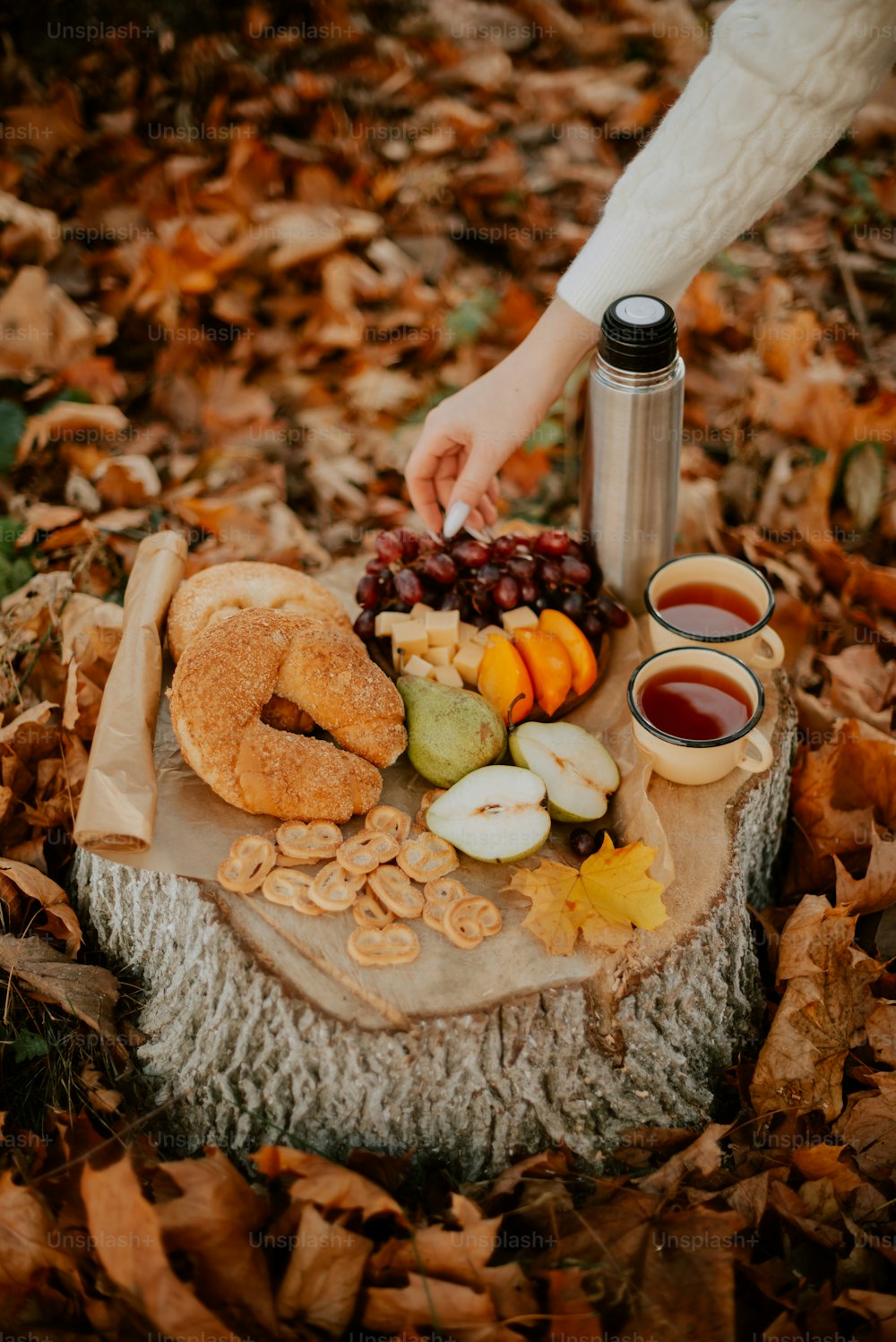 a table topped with donuts, apples, and other foods