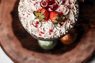 a cake with white frosting and strawberries on top