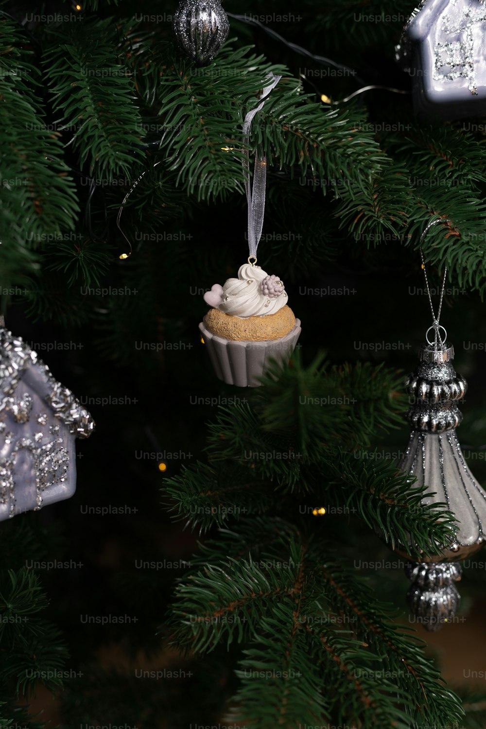a cupcake ornament hanging from a christmas tree