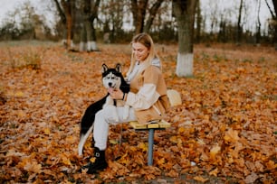 a woman sitting on a bench with a dog