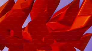 a red sculpture is shown against a blue sky
