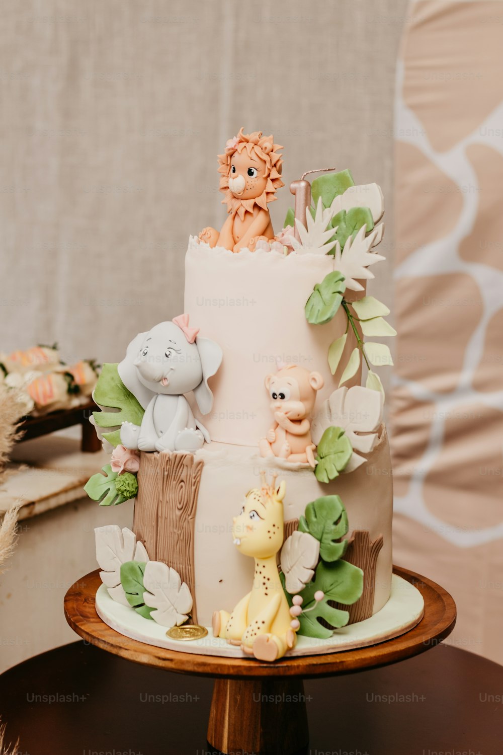 a three tiered cake with animals on top of it