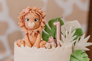 a cake with a lion figurine on top of it