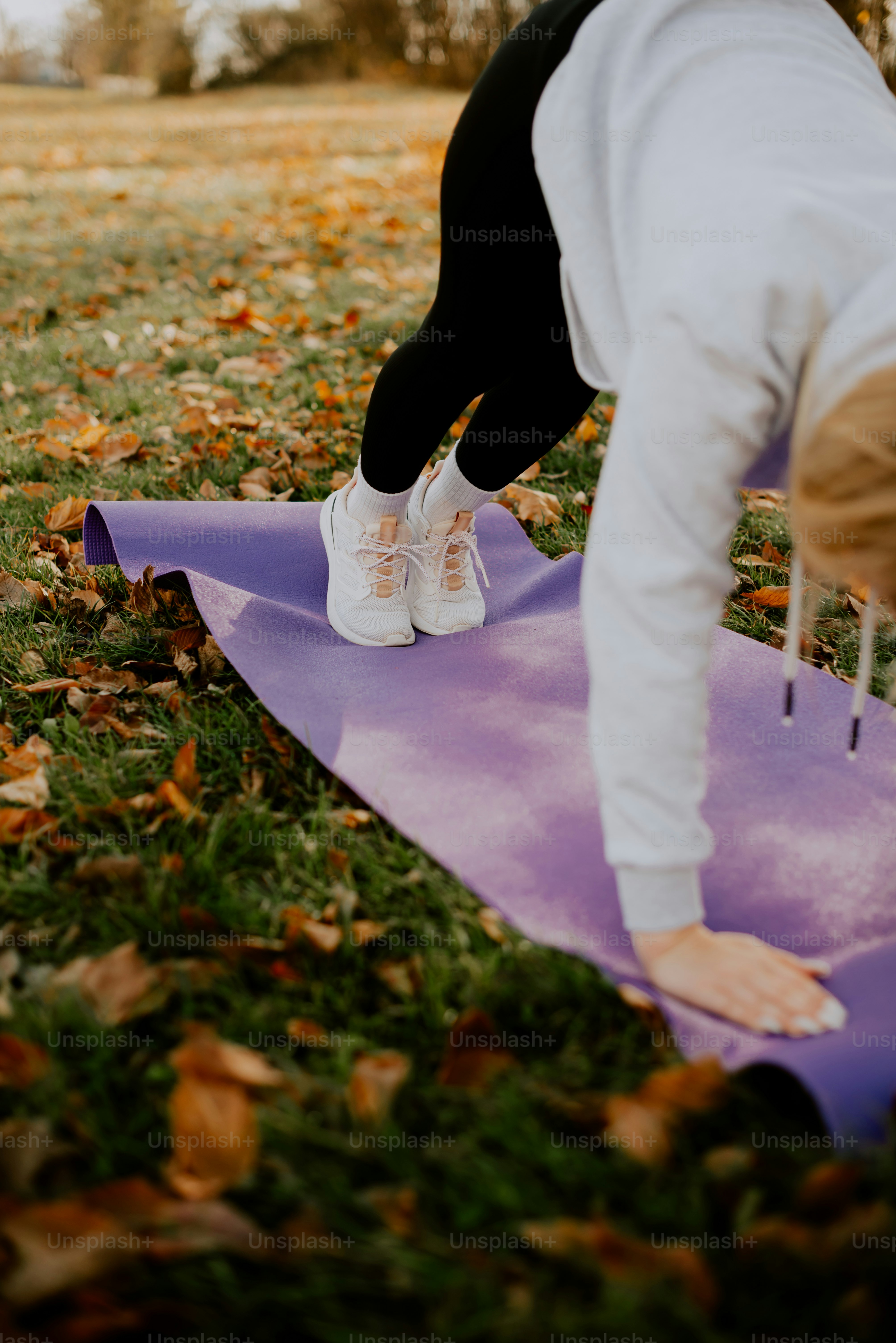 a person standing on top of a purple mat