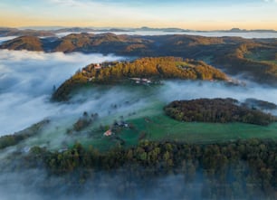 an aerial view of a small village surrounded by fog