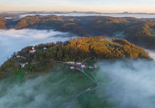 an aerial view of a small village surrounded by fog