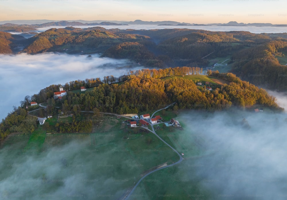 an aerial view of a small village surrounded by fog