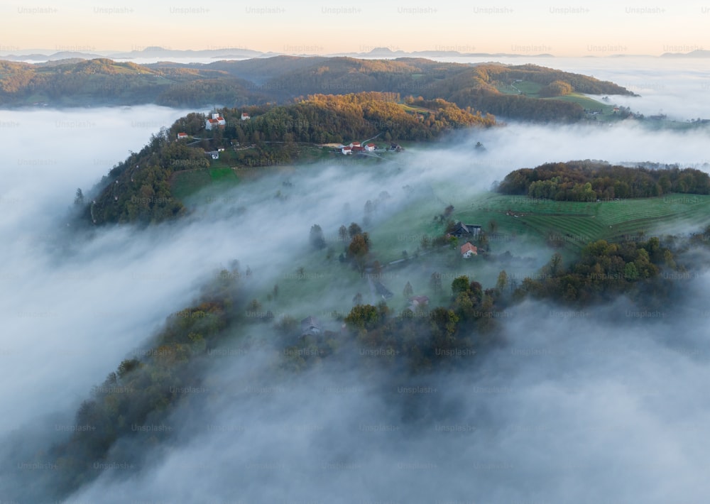 an aerial view of a small town surrounded by fog