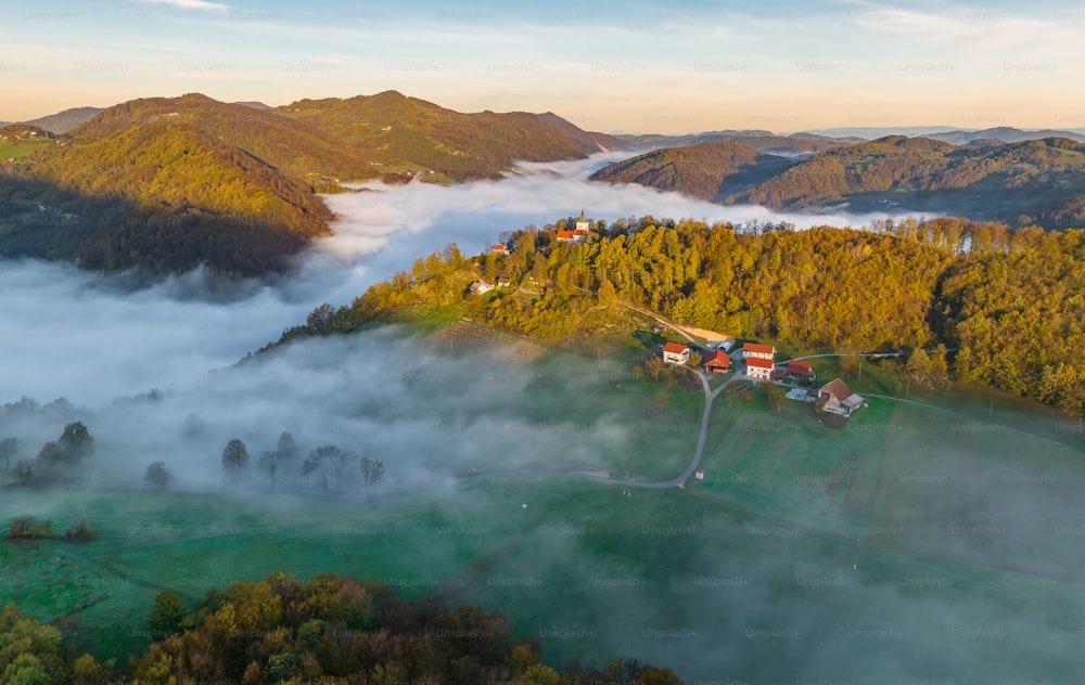 an aerial view of a small village surrounded by fog