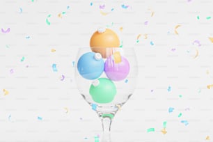 a wine glass filled with colorful balloons and confetti