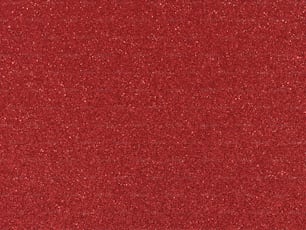 Un primer plano de una superficie texturizada de brillo rojo