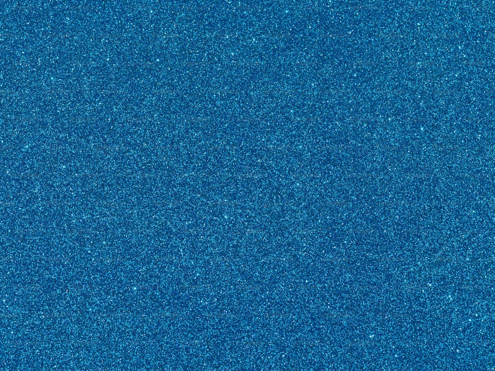 a blue background with a small amount of glitter