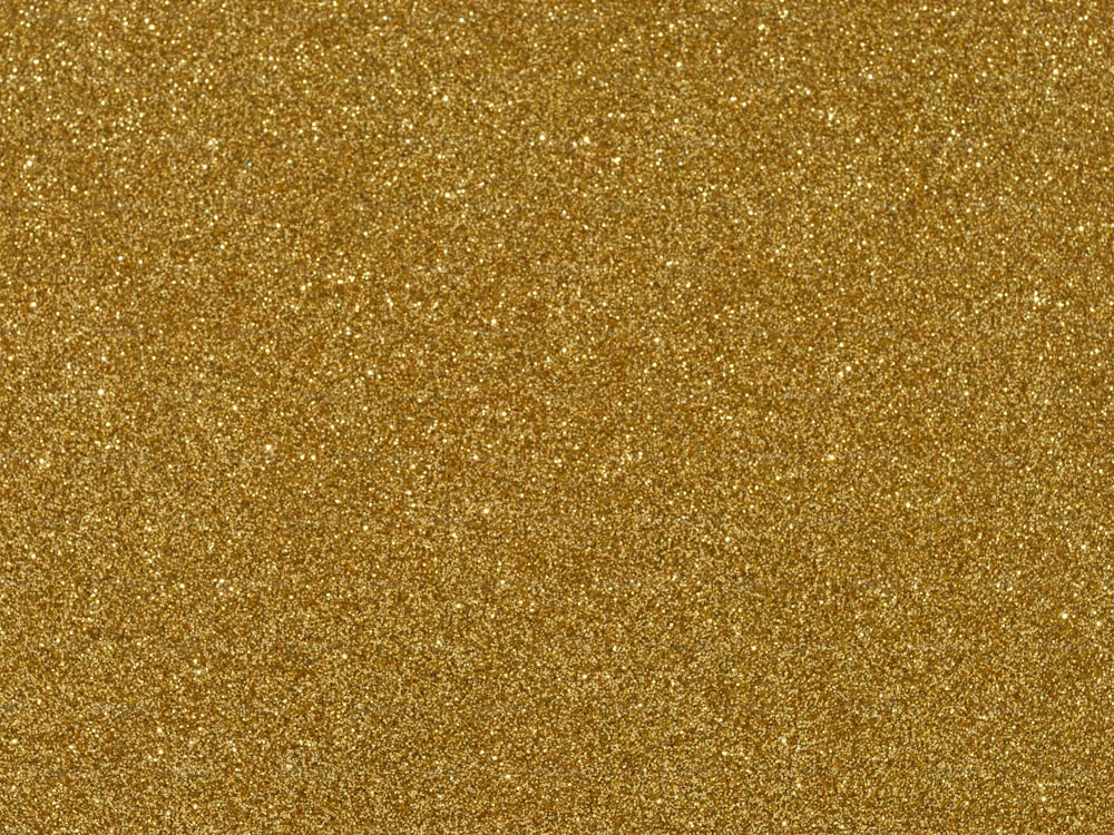 Eine Nahaufnahme eines goldenen Glitzerhintergrunds