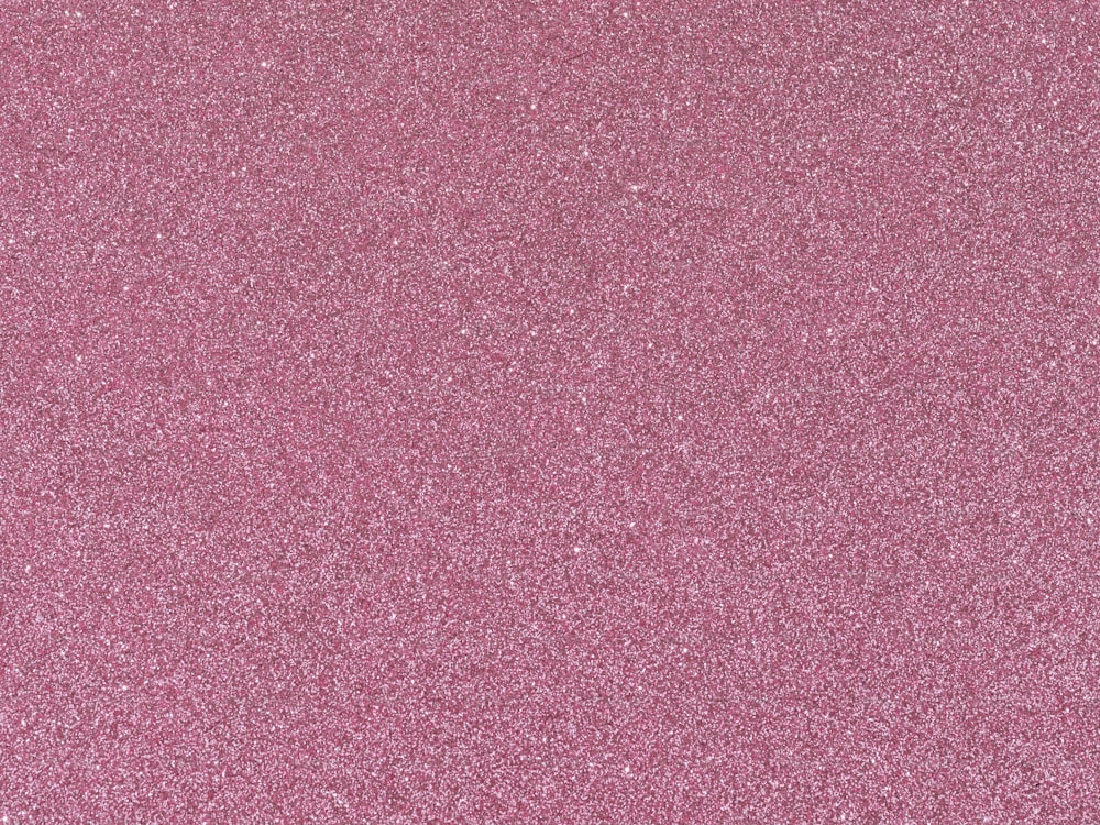 Eine Nahaufnahme eines rosa Glitzerhintergrunds