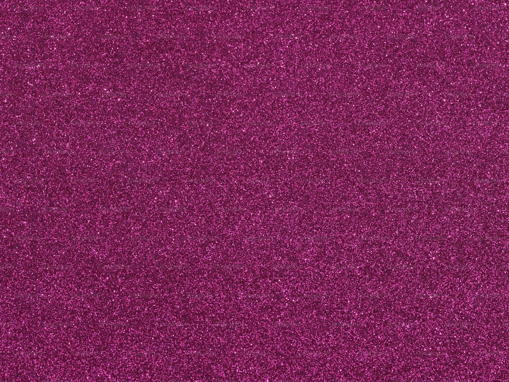 a close up of a purple glitter background