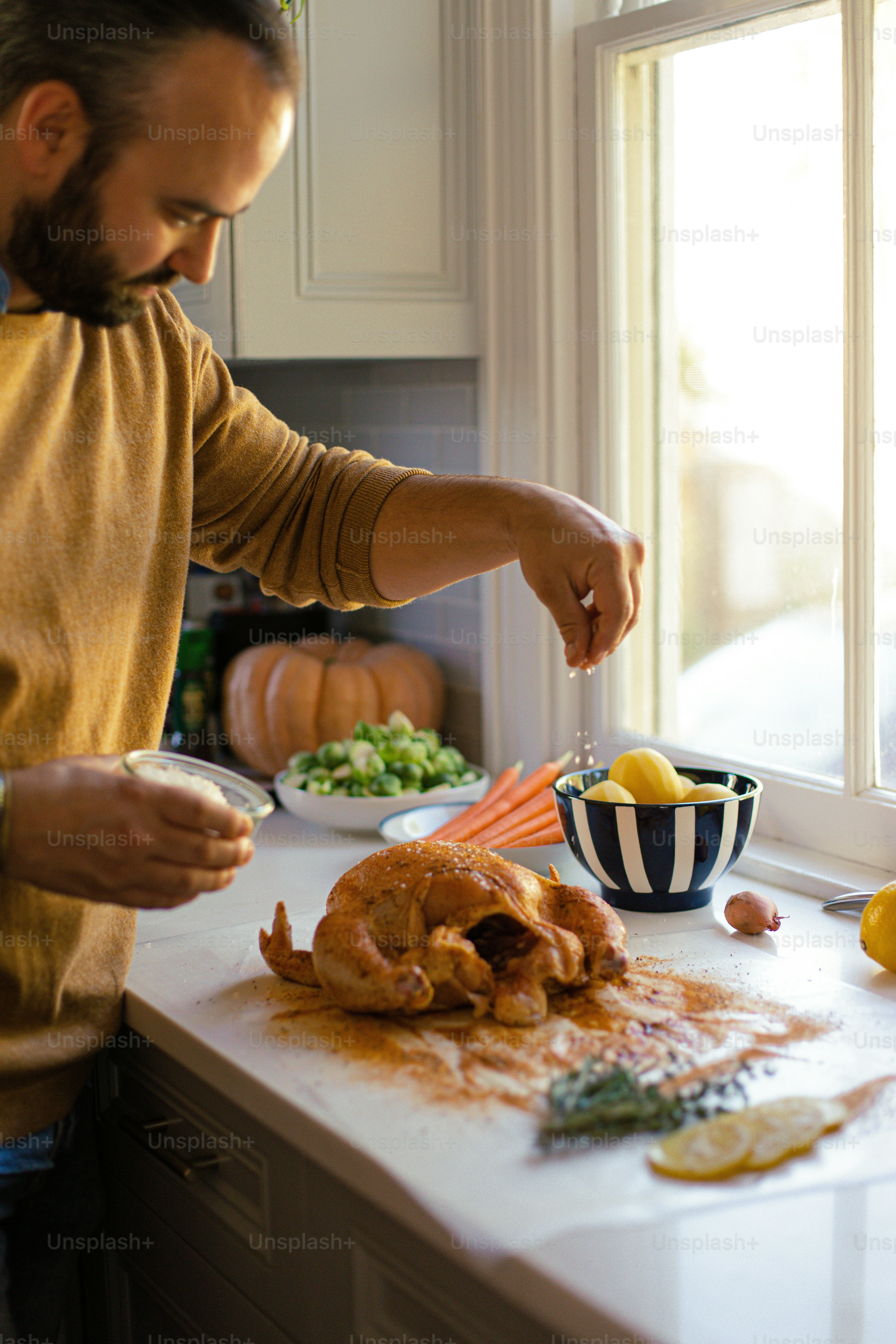a man preparing food on a kitchen counter