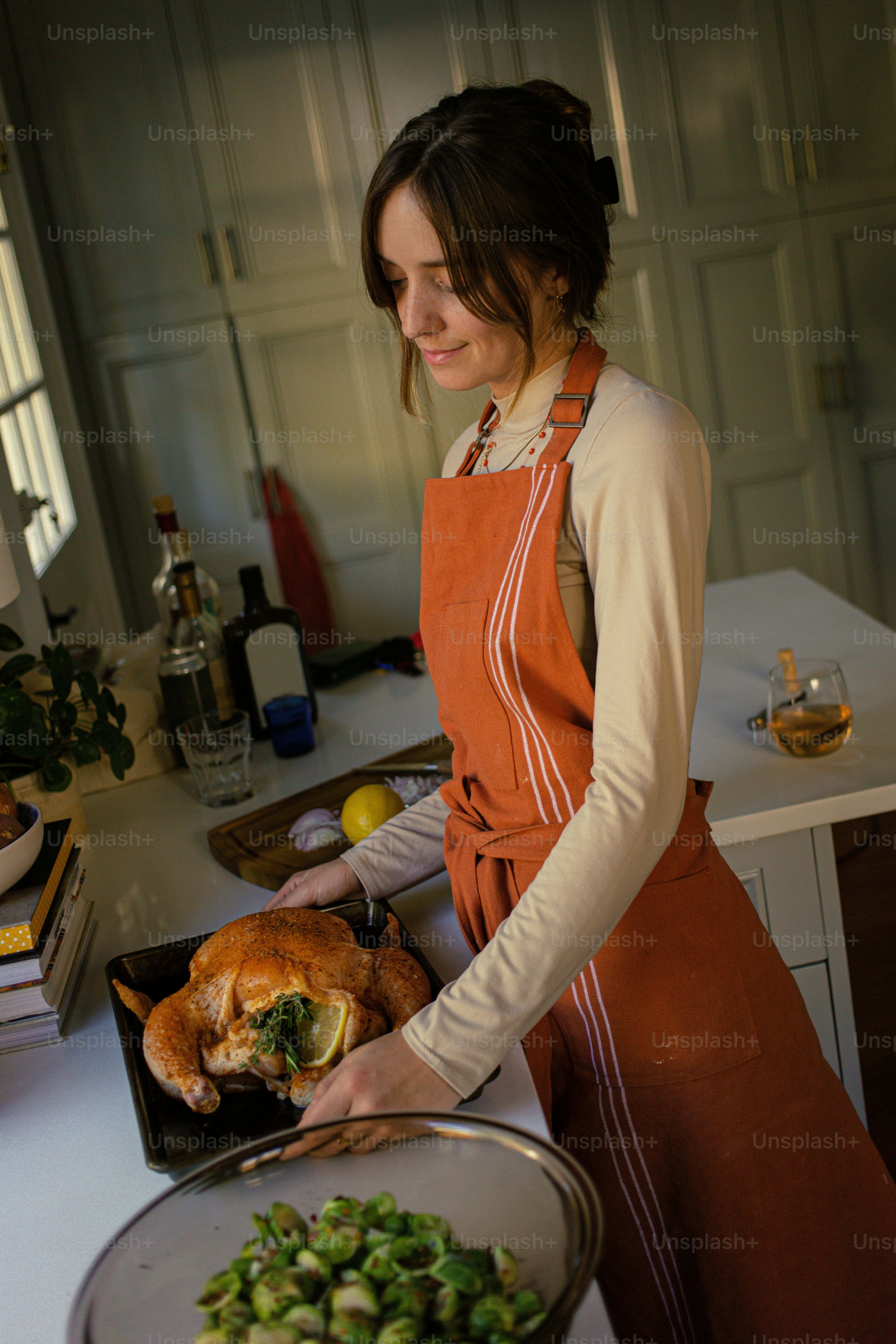 A woman in an apron holding a tray of food photo – Food Image on Unsplash