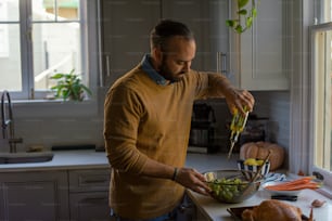 a man standing in a kitchen preparing food