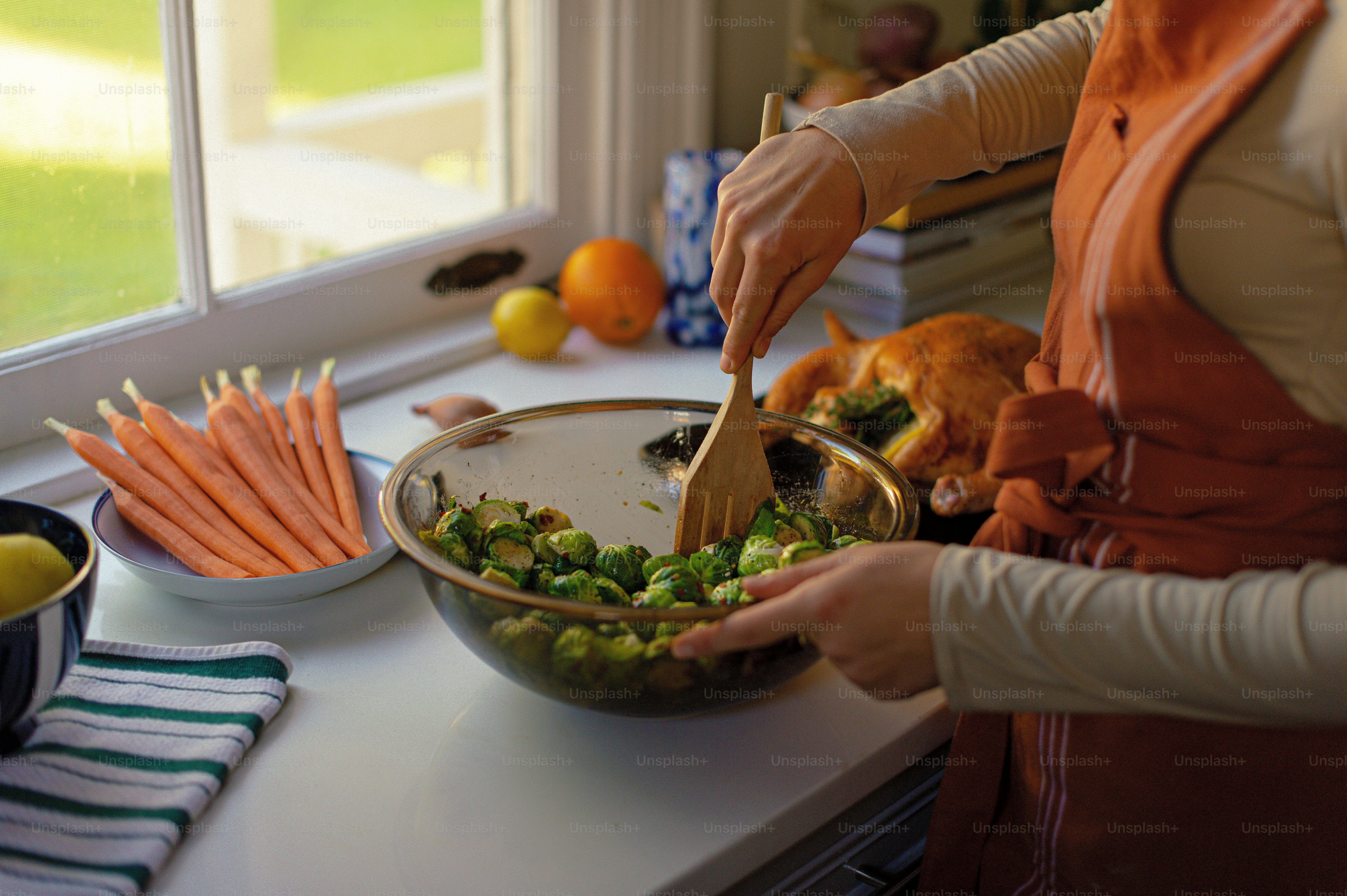 a woman in a kitchen preparing food on a counter