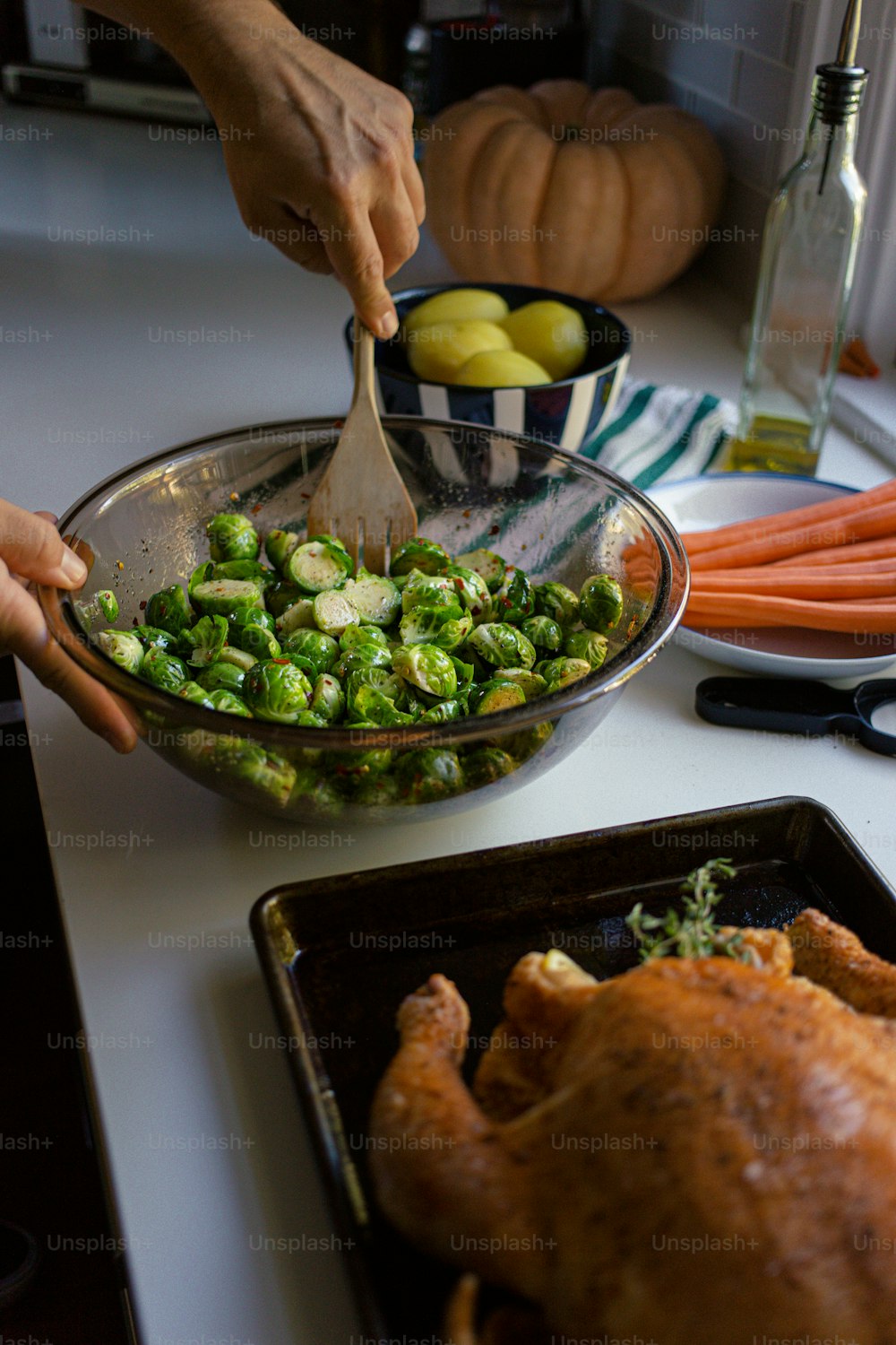 a person scooping vegetables into a bowl