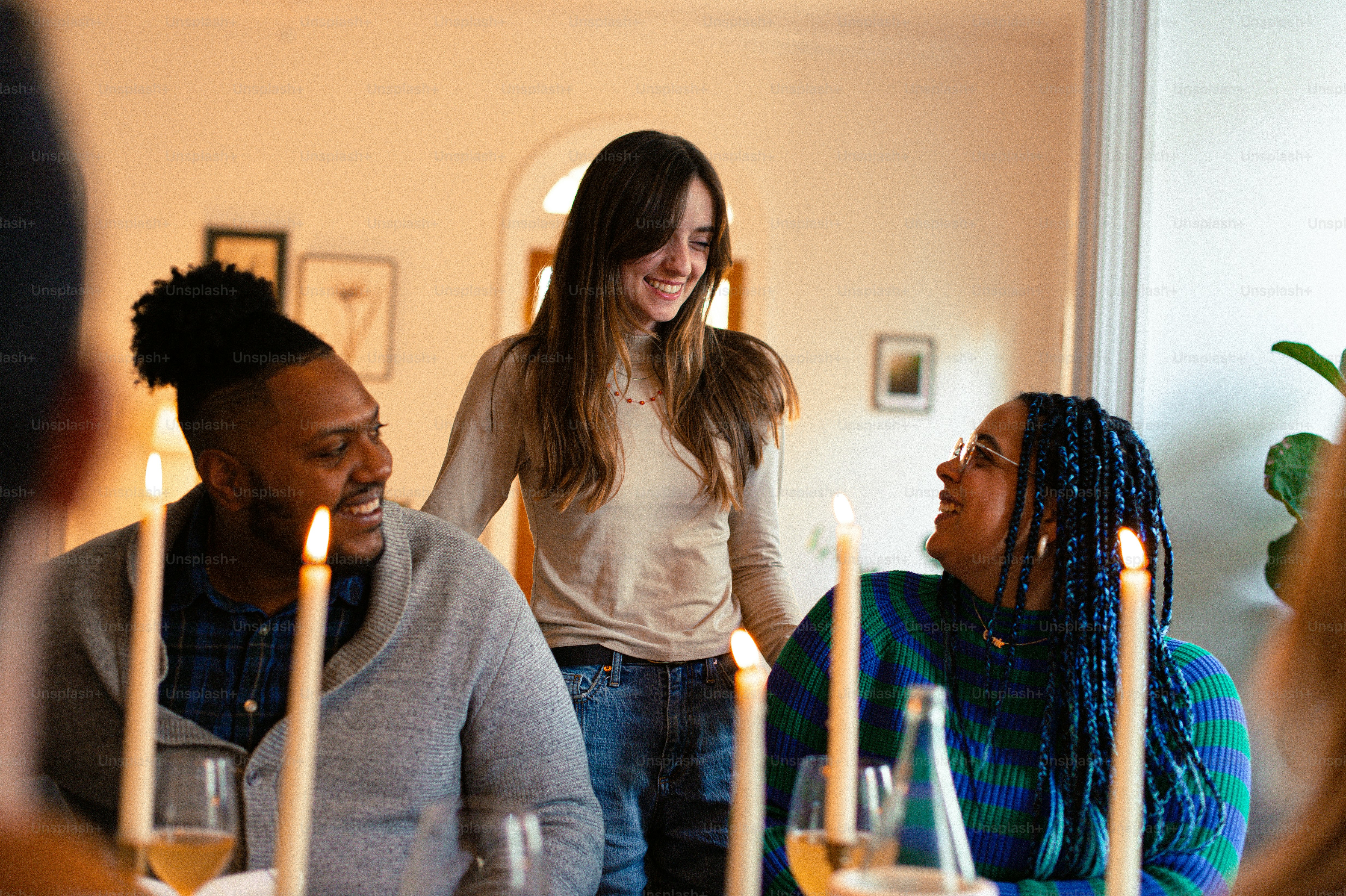 A group of people sitting around a table with wine glasses photo ...