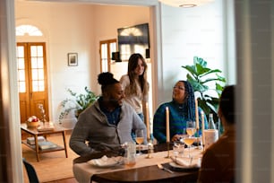 a group of people sitting around a dining room table