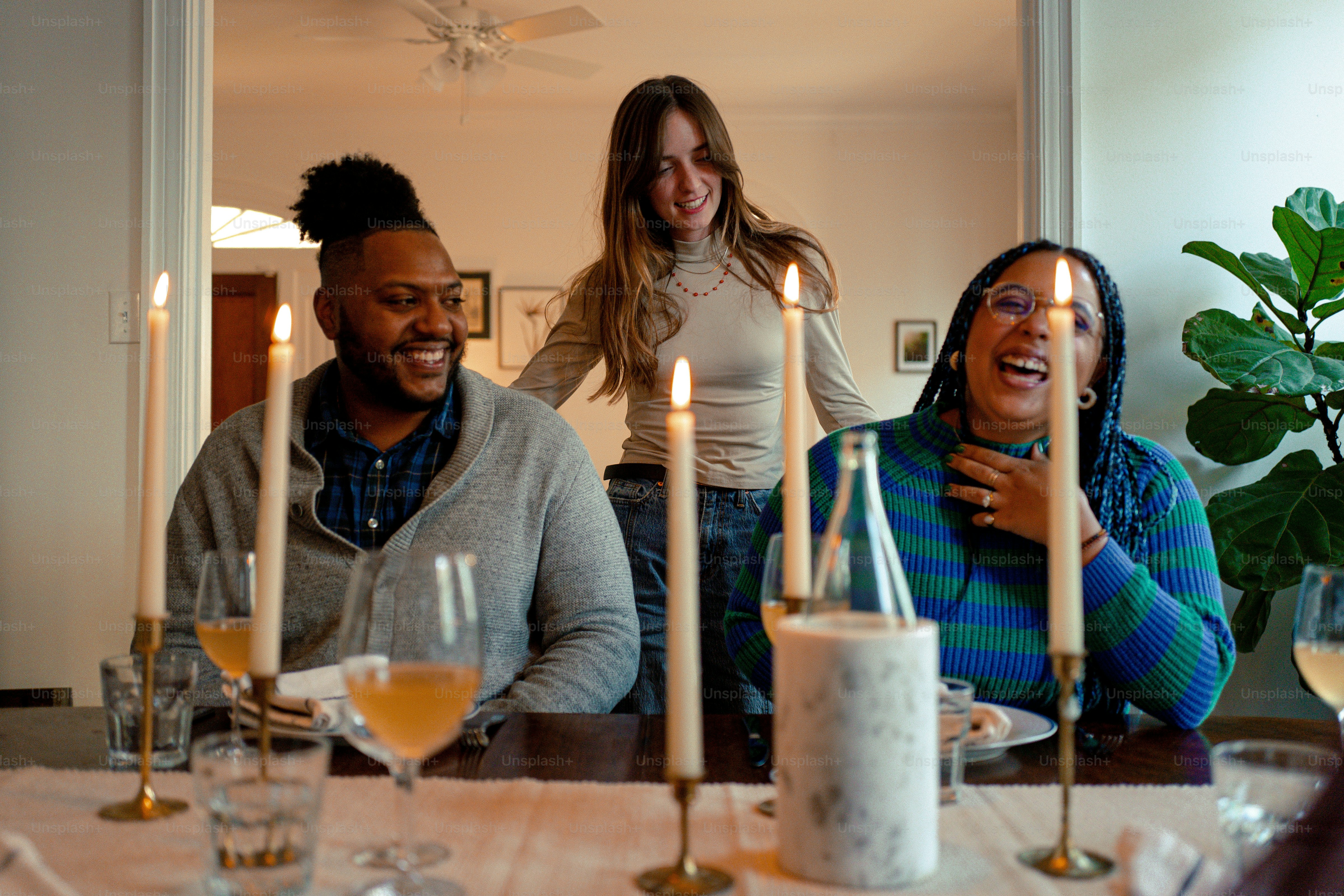 a group of people sitting around a dinner table