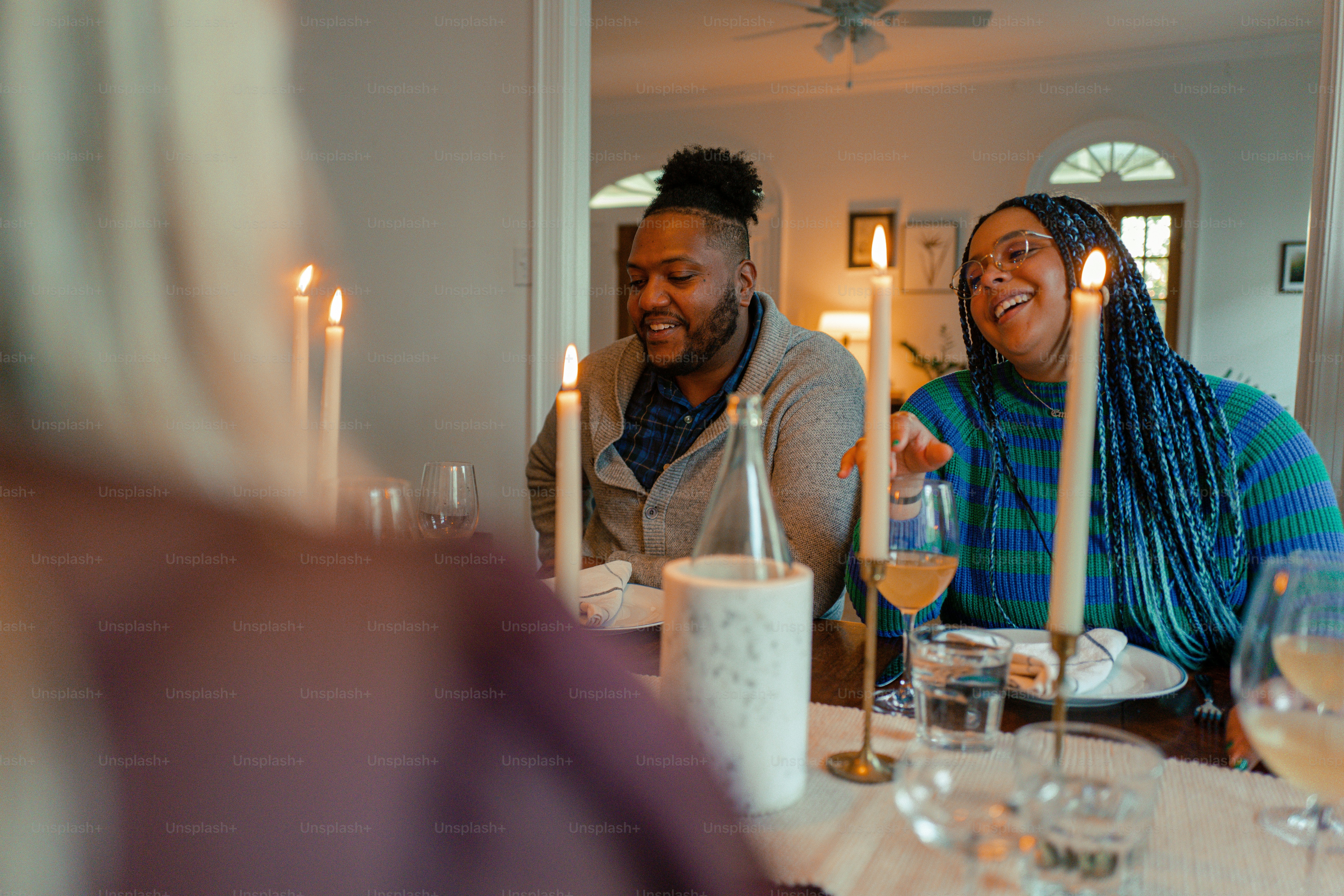 a man and a woman sitting at a table with wine glasses