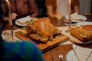 a turkey sitting on a cutting board on a table