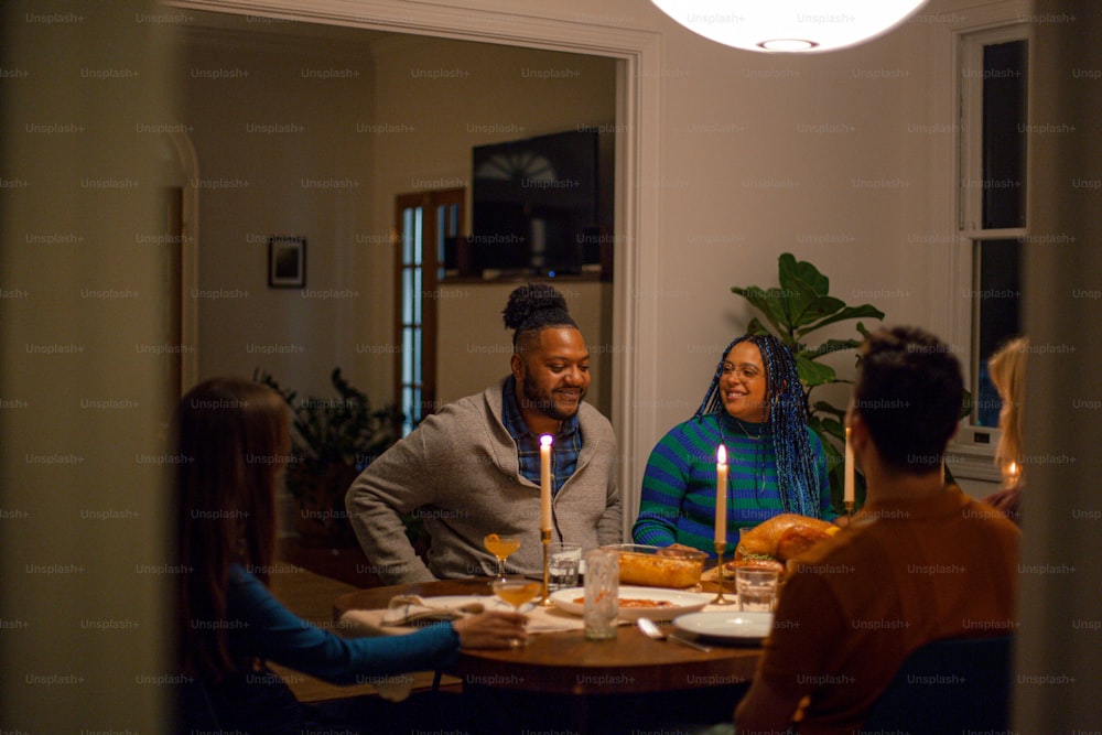 a group of people sitting around a dinner table