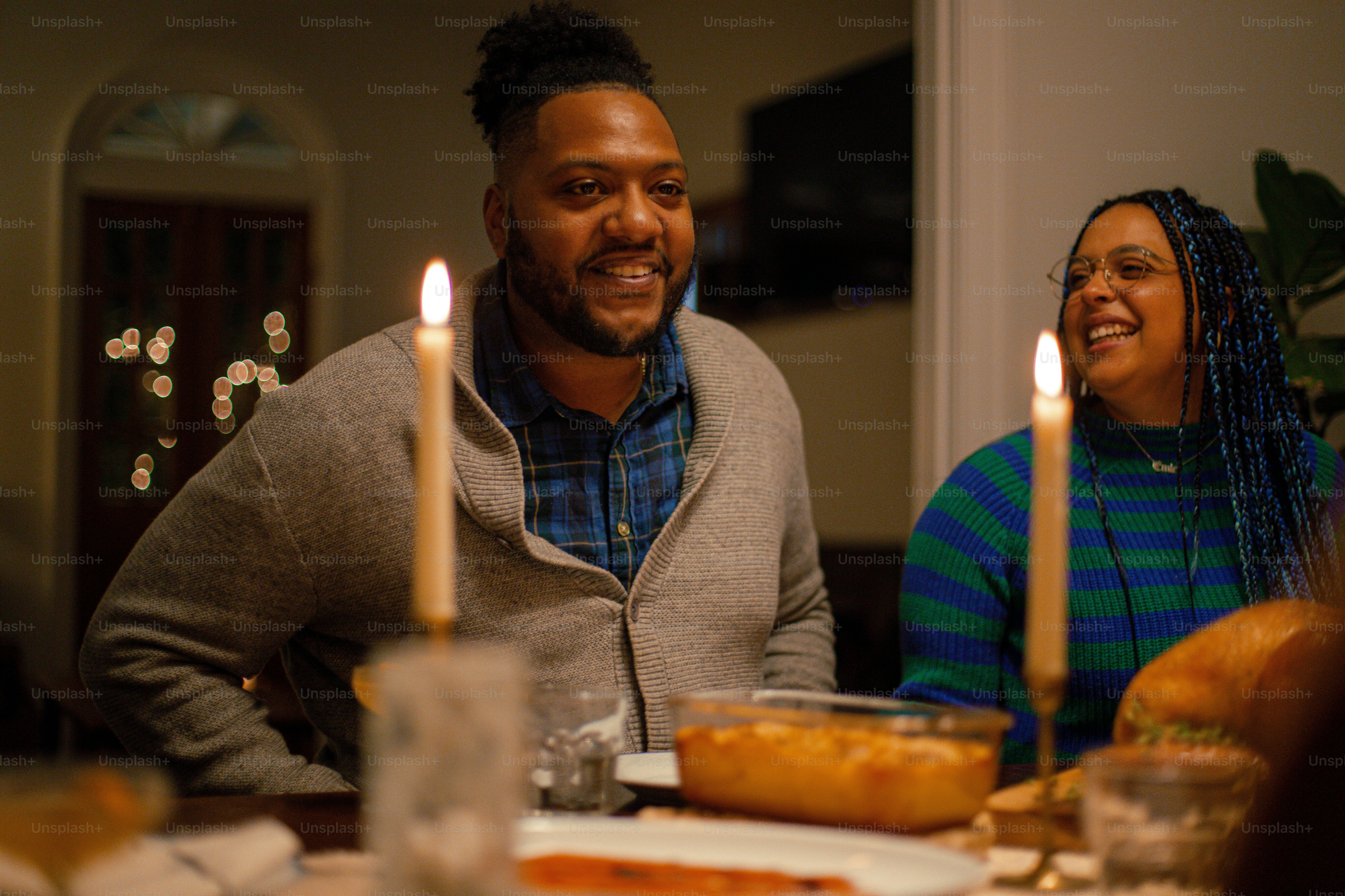 a man and woman sitting at a dinner table