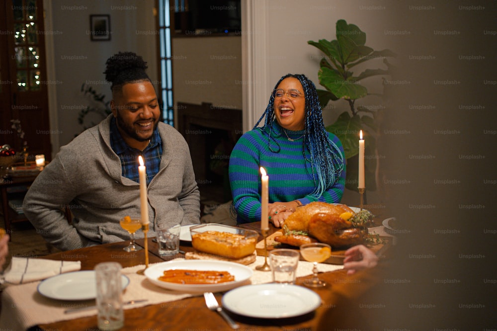 a group of people sitting around a table with food