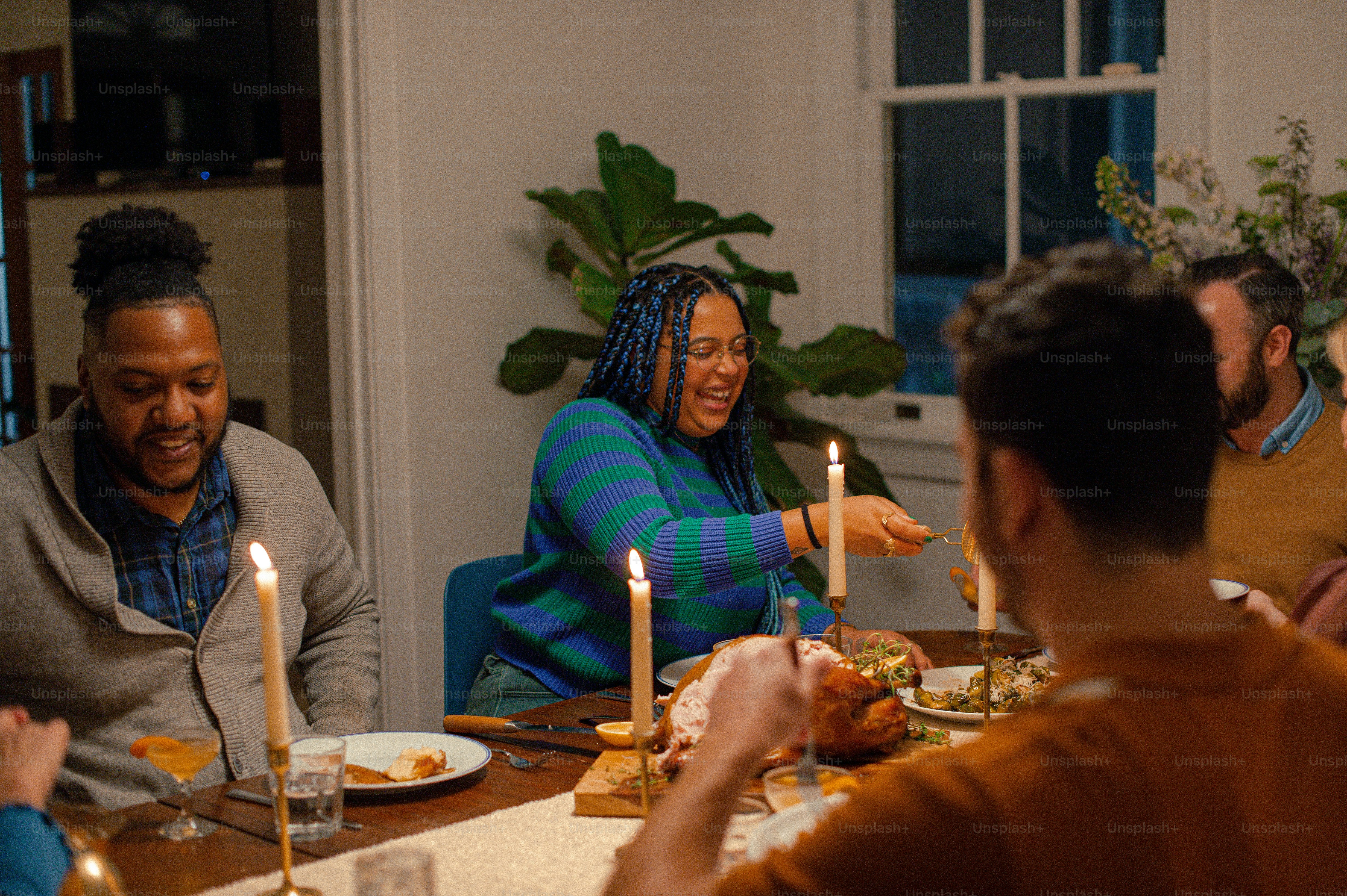 A group of people sitting around a dinner table photo – Adult Image on