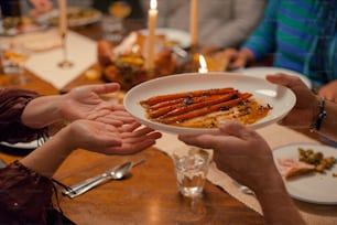 a group of people holding a plate of food