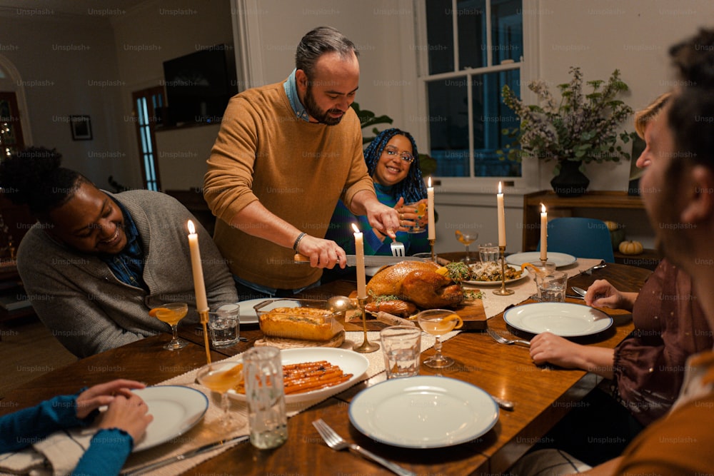 a group of people sitting around a table with plates of food