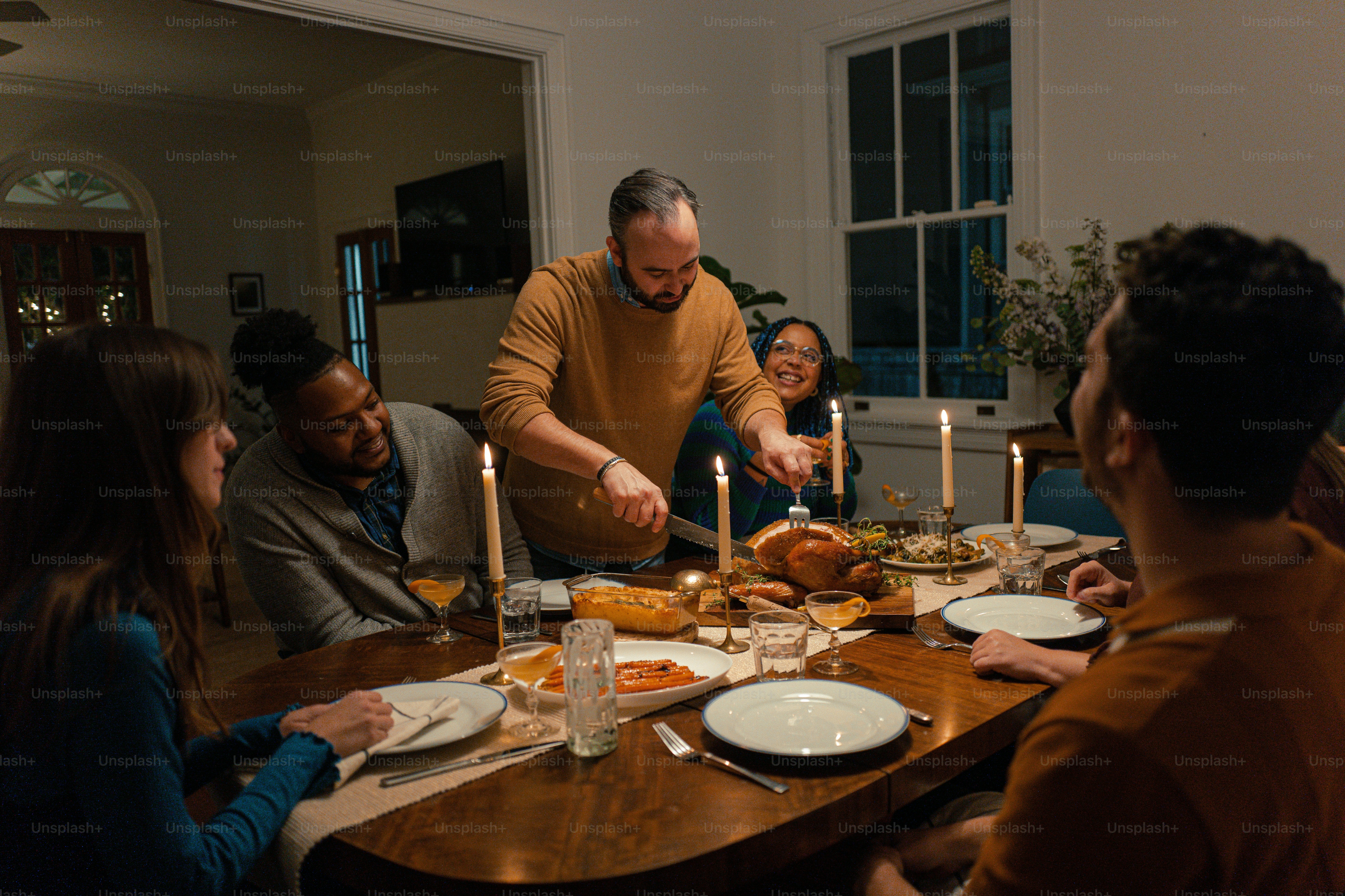 a group of people sitting around a table with food