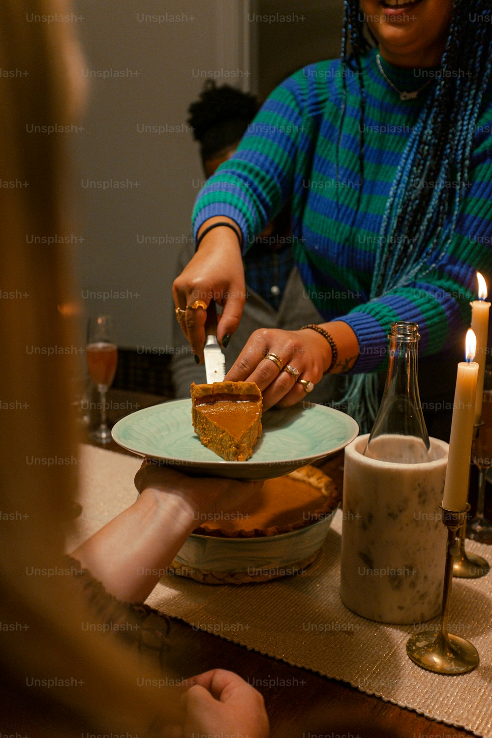 a woman cutting a piece of pie on a plate