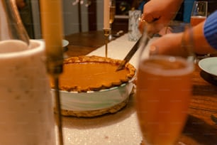 a person cutting a pie with a knife