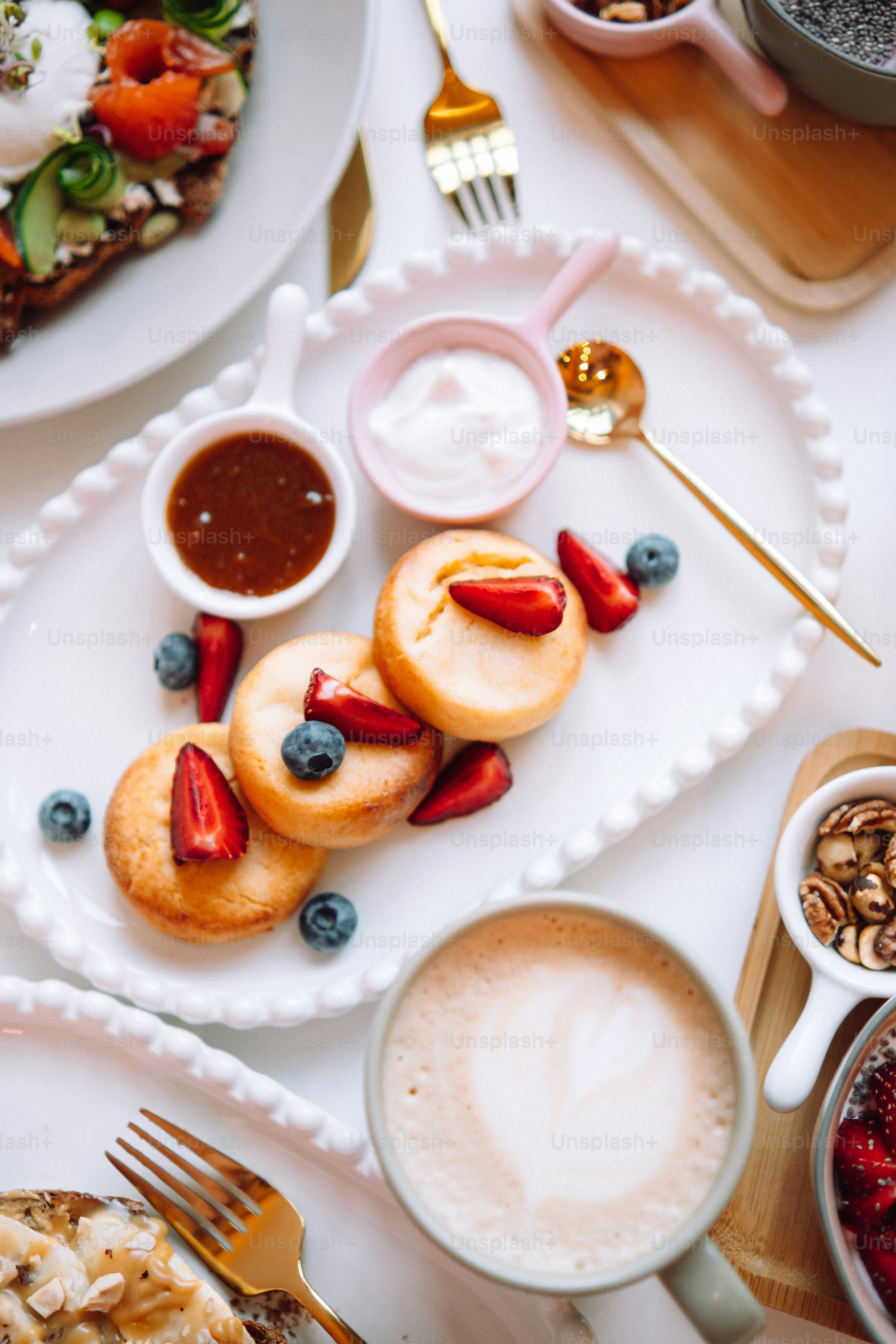 a white plate topped with cookies next to a cup of coffee