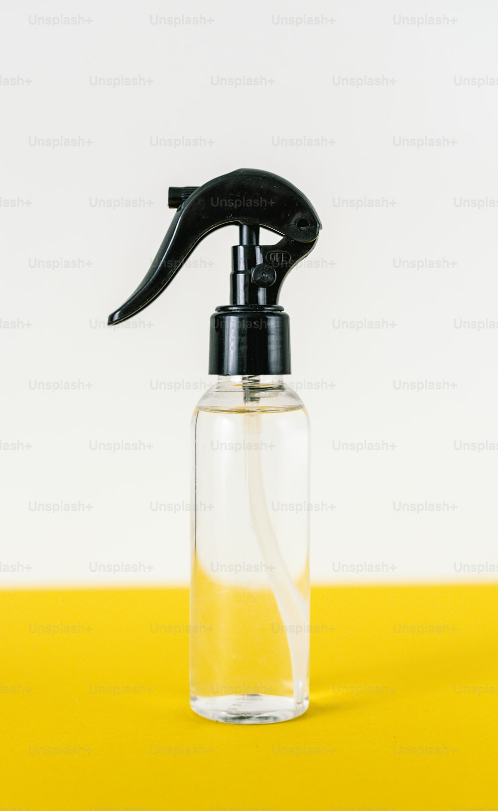 a bottle of liquid with a black sprayer on top of it