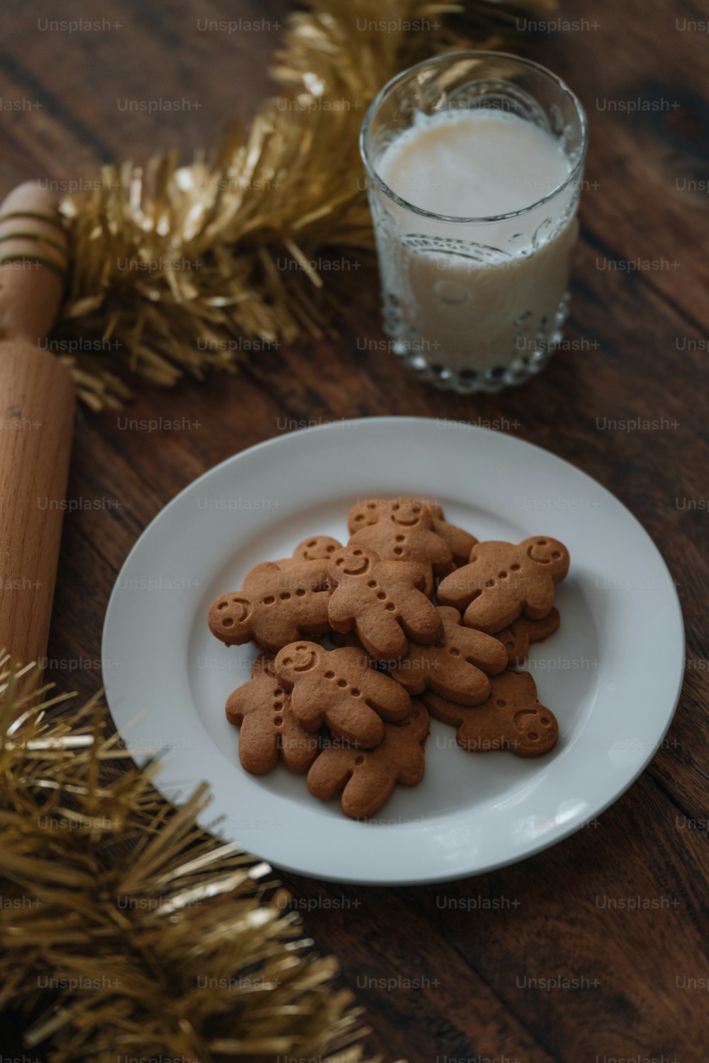 a plate of cookies next to a glass of milk