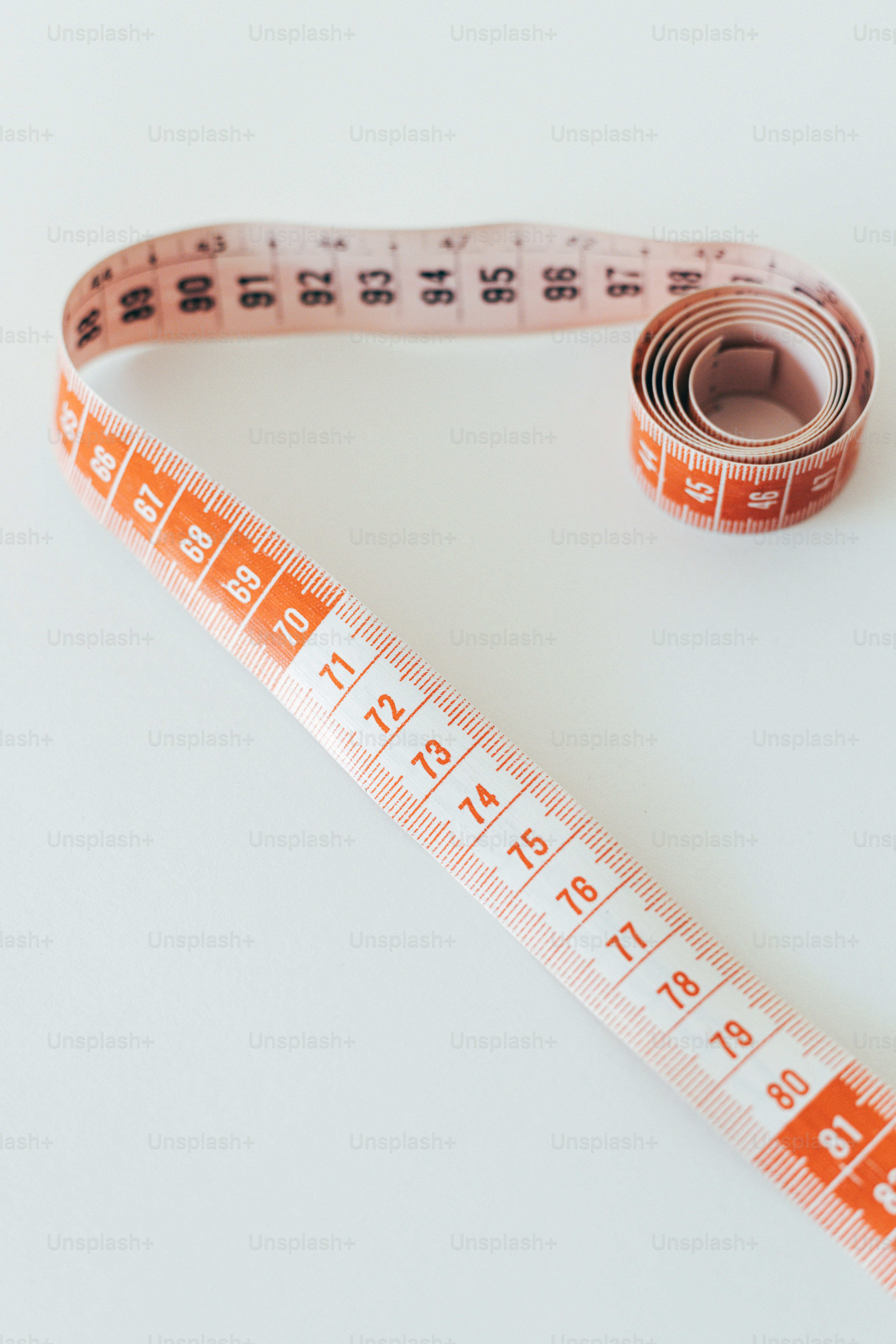 a measuring tape and a roll of tape on a table